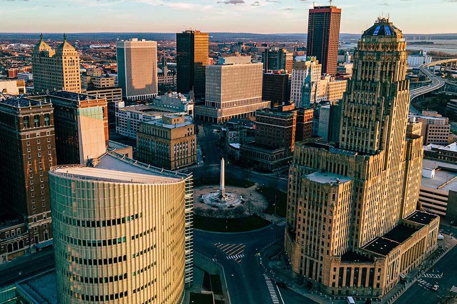 Contact - Aerial View of Buffalo, NY Displaying Many Tall Business Buildings During Sunset